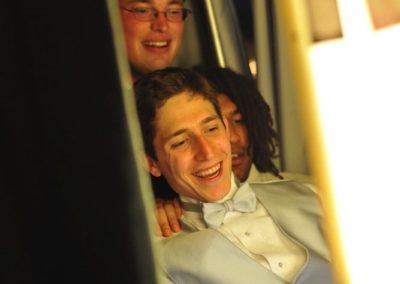 Three people in a photo booth.