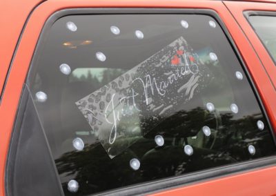 A "Just Married" sign on the window of a car.