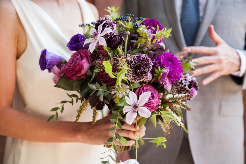 A loose bridal bouquet in pinks and purples.