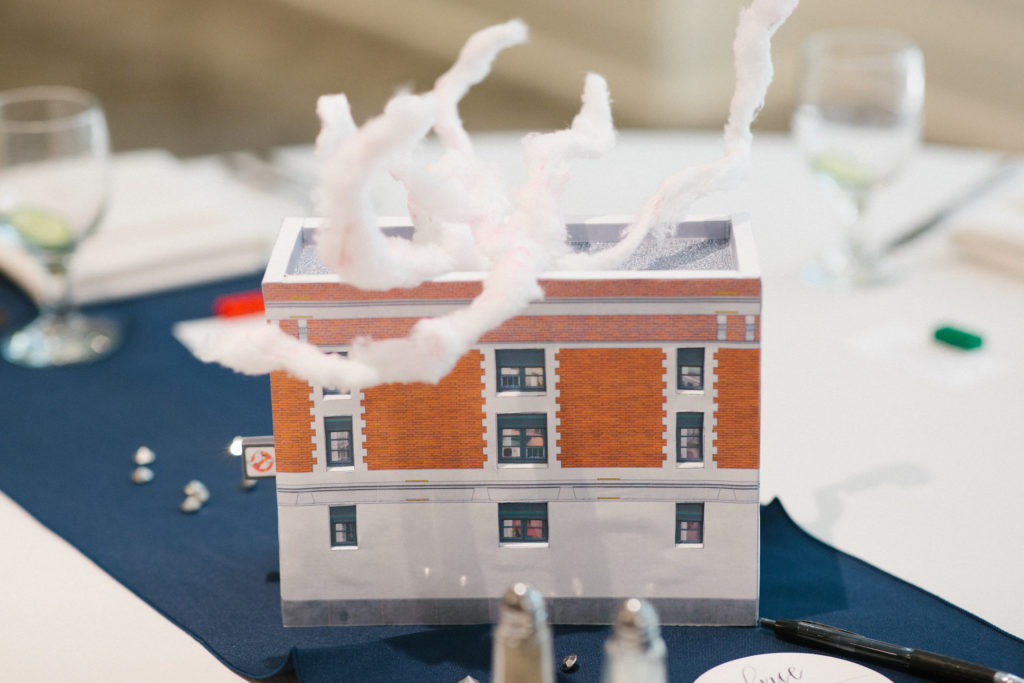 A model of a brick building with smoke rising from the roof.