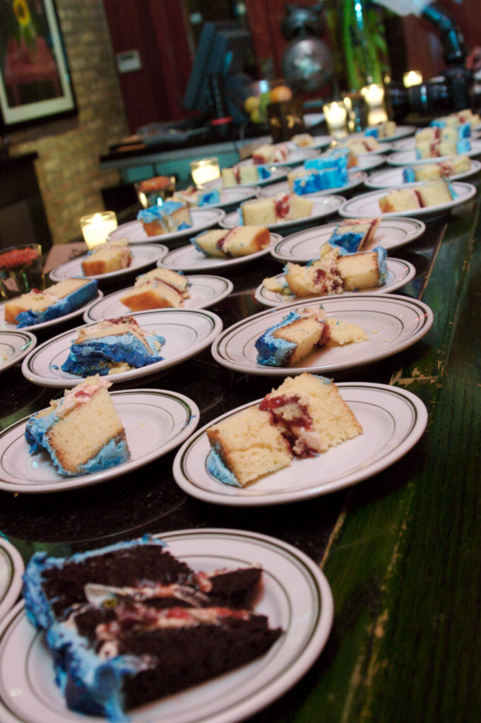 Rows of cake plates lined up on a bar.